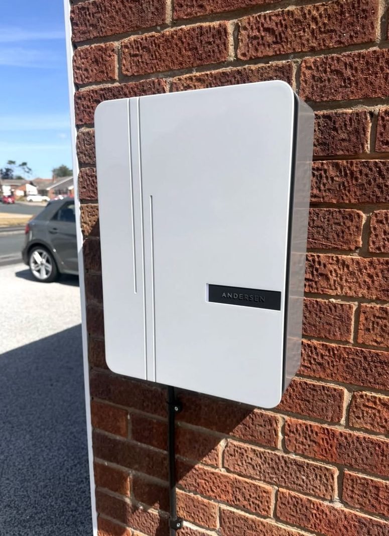 White EV charger on a brick wall