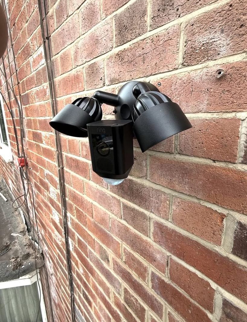 Floodlight camera on a brick wall