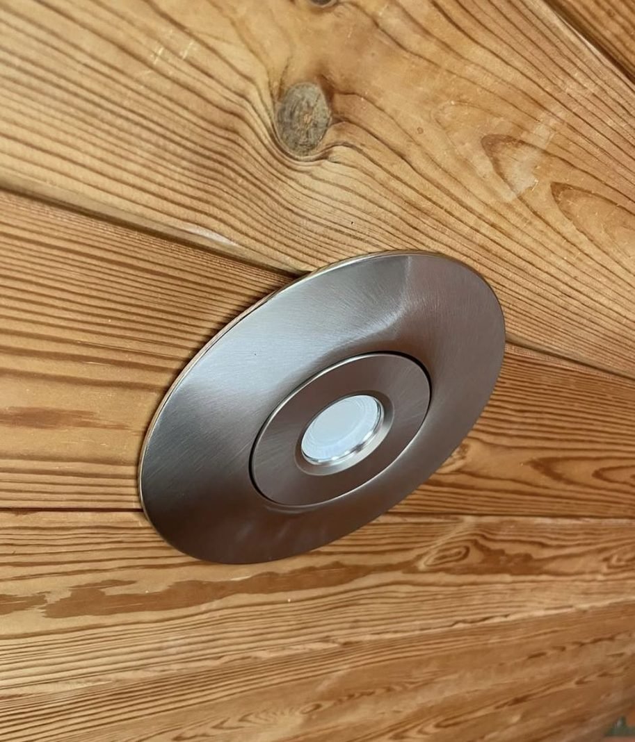 Steel downlight in a timber ceiling